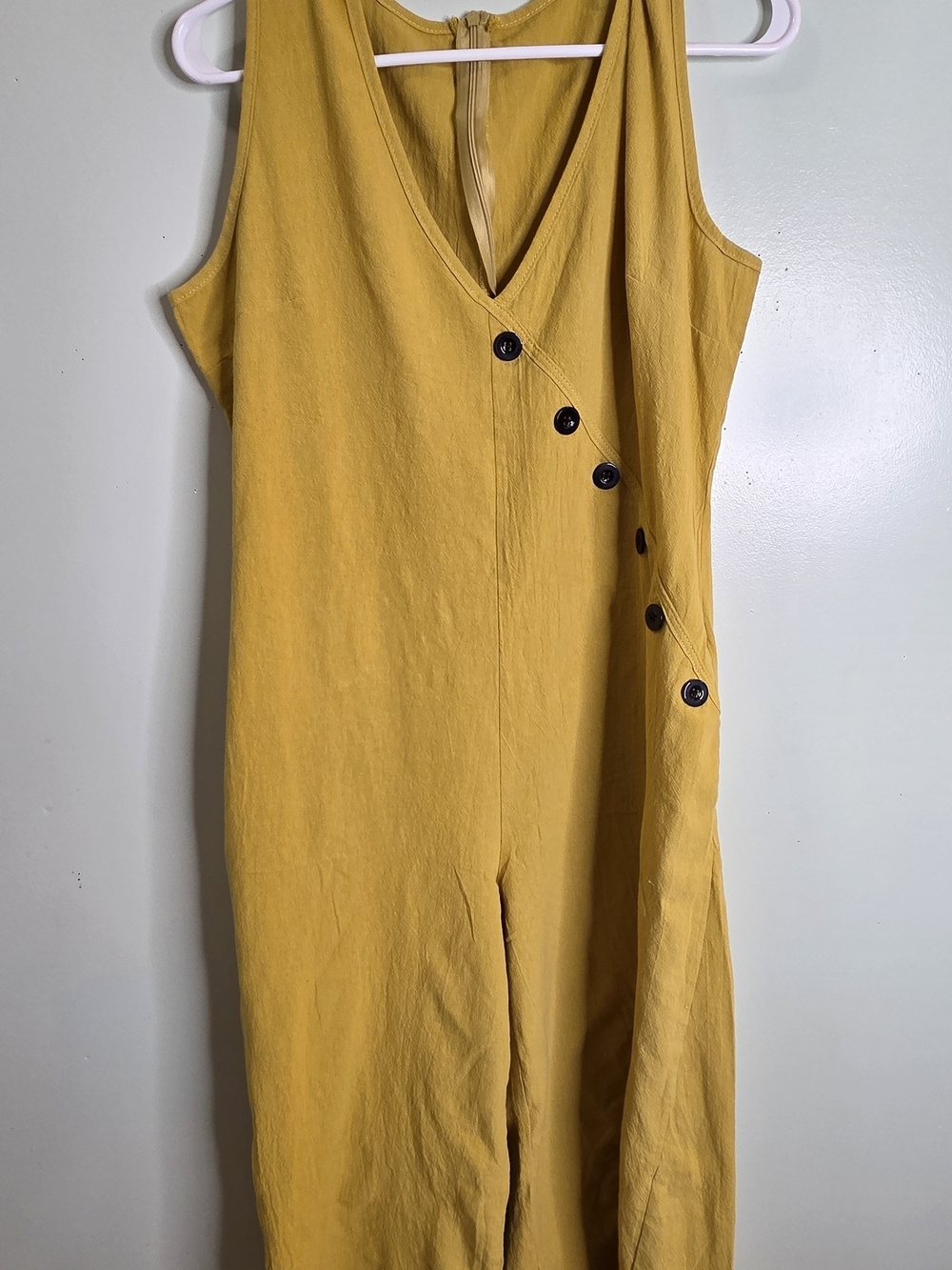 Sleeveless Mustard Yellow V‑Neck Jumpsuit with Side Button Detail